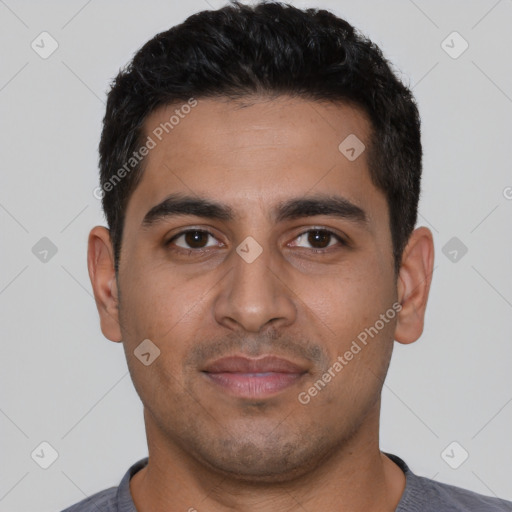 Joyful latino young-adult male with short  black hair and brown eyes