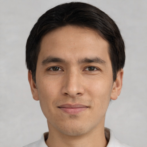 Joyful white young-adult male with short  black hair and brown eyes