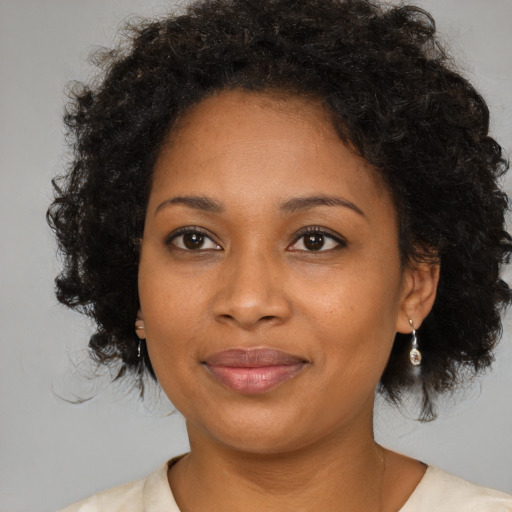 Joyful black young-adult female with medium  brown hair and brown eyes