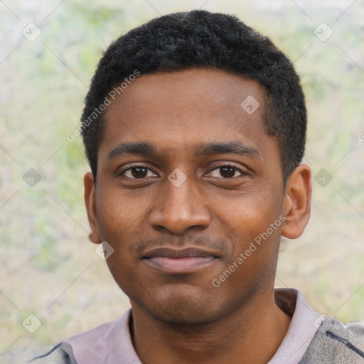 Joyful black young-adult male with short  black hair and brown eyes