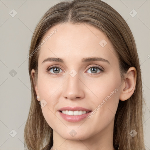 Joyful white young-adult female with long  brown hair and grey eyes