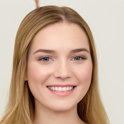 Joyful white young-adult female with long  brown hair and blue eyes