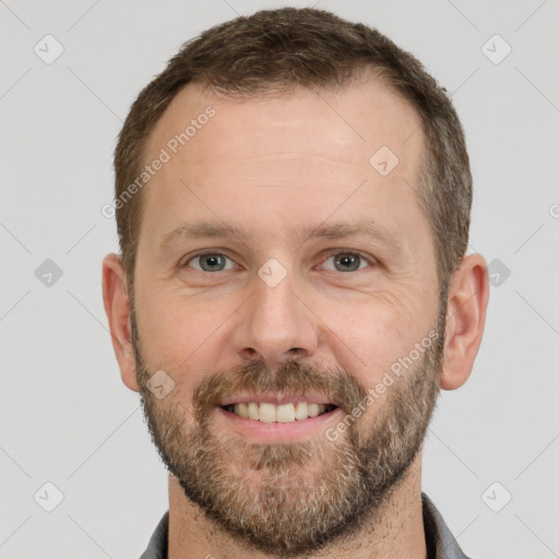 Joyful white adult male with short  brown hair and grey eyes