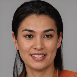 Joyful latino young-adult female with medium  brown hair and brown eyes