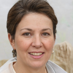 Joyful white adult female with short  brown hair and brown eyes