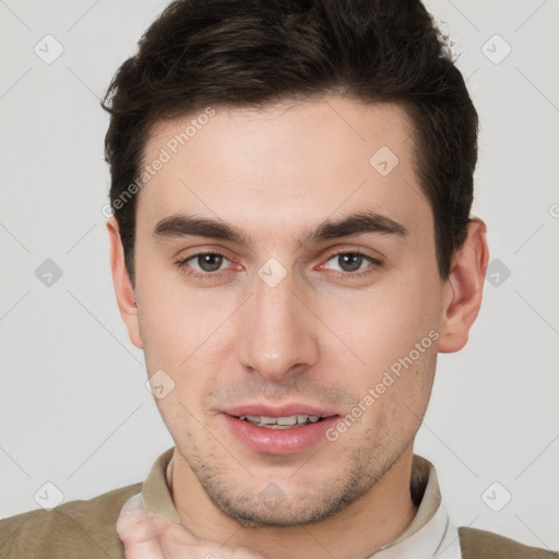 Joyful white young-adult male with short  brown hair and brown eyes