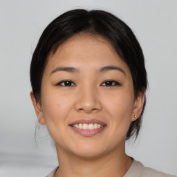 Joyful asian young-adult female with medium  brown hair and brown eyes