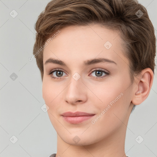 Joyful white young-adult female with short  brown hair and grey eyes