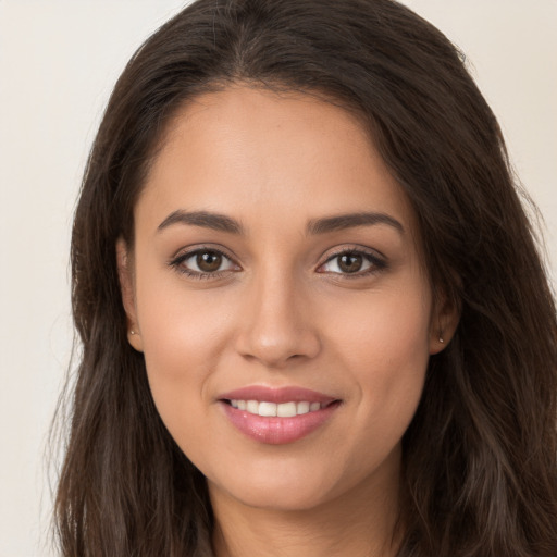 Joyful white young-adult female with long  brown hair and brown eyes