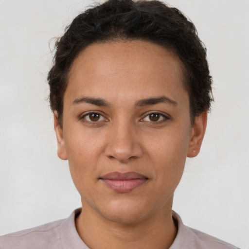 Joyful latino young-adult female with short  brown hair and brown eyes