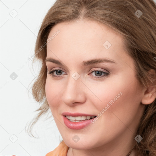 Joyful white young-adult female with medium  brown hair and blue eyes