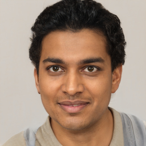Joyful latino young-adult male with short  black hair and brown eyes