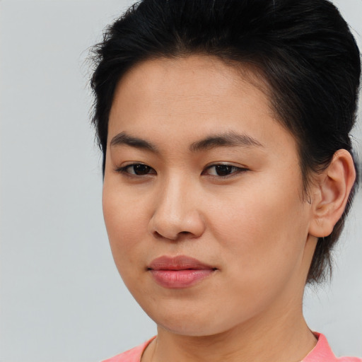 Joyful asian young-adult female with short  brown hair and brown eyes