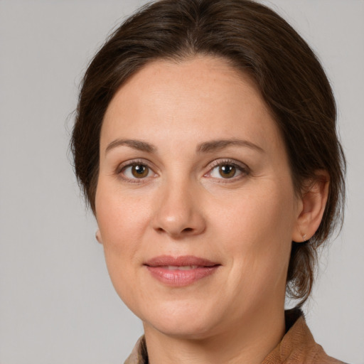 Joyful white young-adult female with medium  brown hair and green eyes