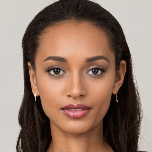 Joyful latino young-adult female with long  brown hair and brown eyes