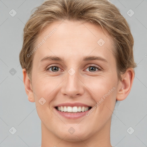 Joyful white young-adult female with short  brown hair and grey eyes