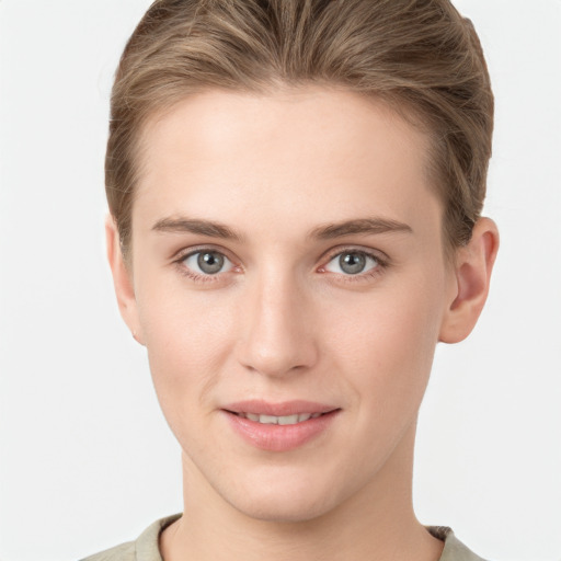 Joyful white young-adult female with short  brown hair and grey eyes