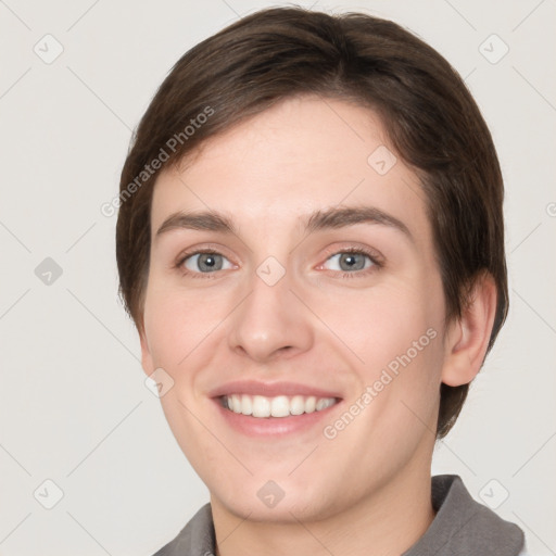 Joyful white young-adult female with short  brown hair and grey eyes