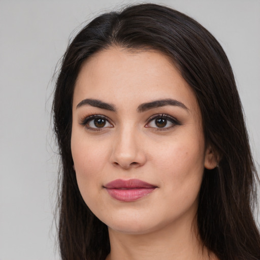 Joyful white young-adult female with long  brown hair and brown eyes