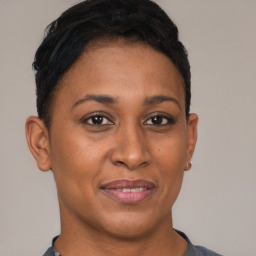 Joyful black young-adult female with short  brown hair and brown eyes