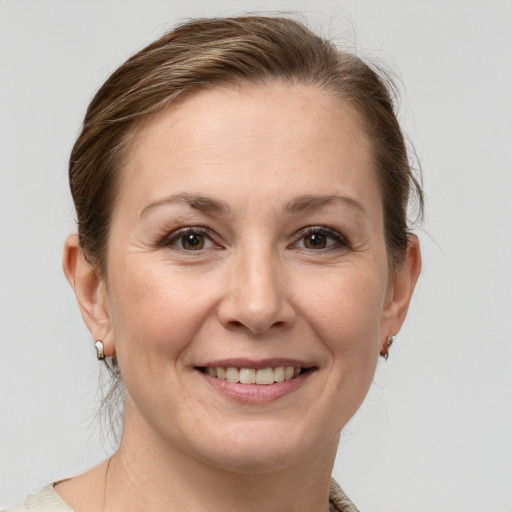 Joyful white adult female with medium  brown hair and grey eyes