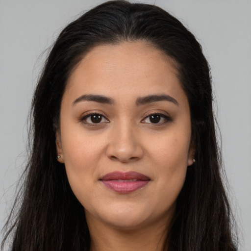 Joyful latino young-adult female with long  brown hair and brown eyes