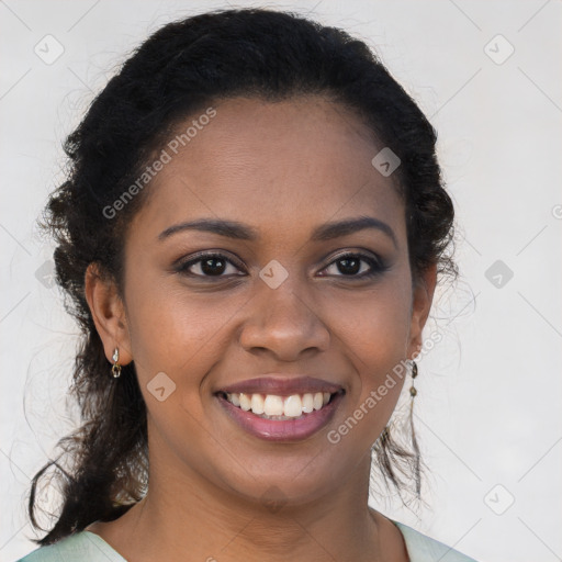 Joyful black young-adult female with long  brown hair and brown eyes