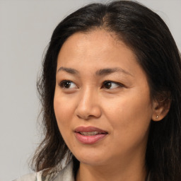 Joyful asian young-adult female with medium  brown hair and brown eyes