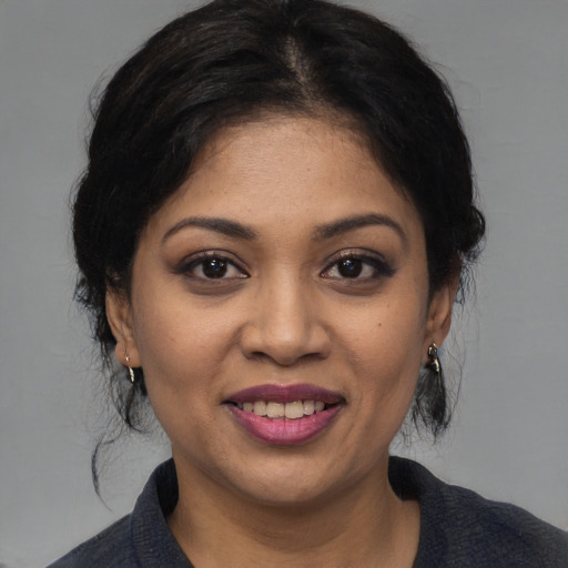 Joyful black young-adult female with medium  black hair and brown eyes