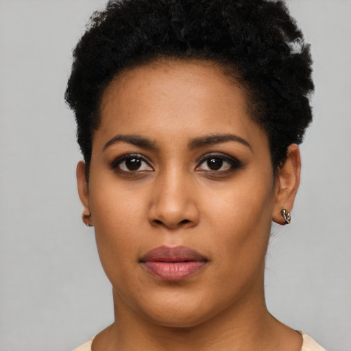 Joyful latino young-adult female with short  black hair and brown eyes
