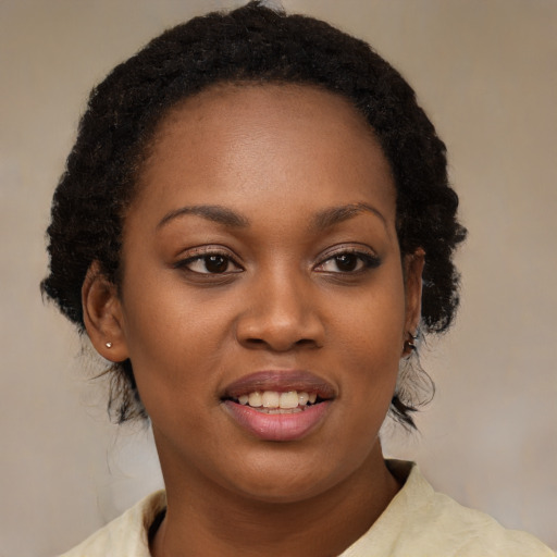 Joyful black young-adult female with medium  brown hair and brown eyes