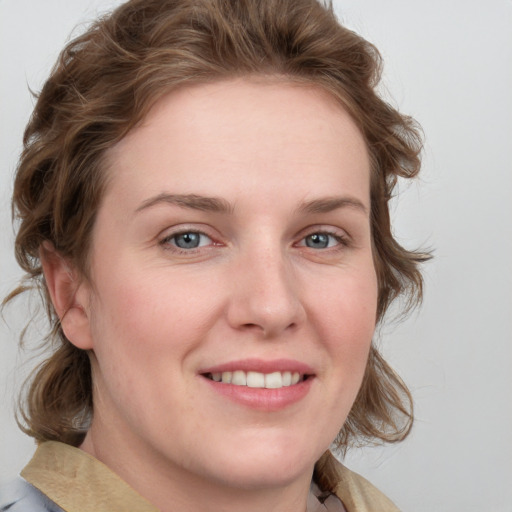 Joyful white young-adult female with medium  brown hair and blue eyes