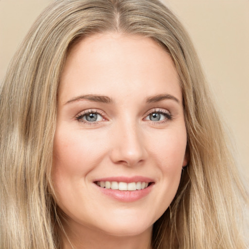 Joyful white young-adult female with long  brown hair and green eyes