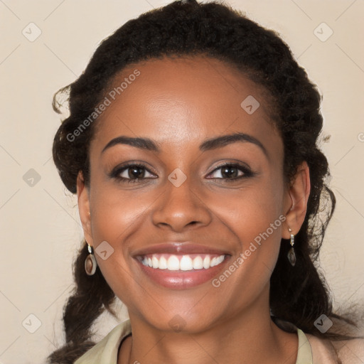 Joyful black young-adult female with long  brown hair and brown eyes