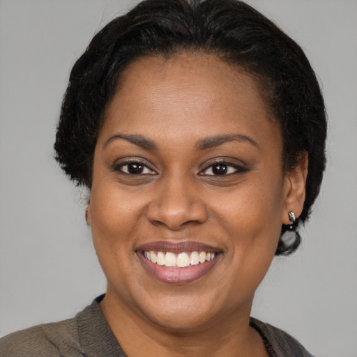 Joyful latino young-adult female with short  brown hair and brown eyes
