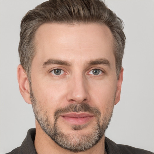 Joyful white adult male with short  brown hair and grey eyes