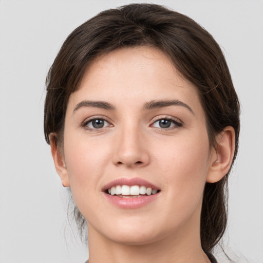 Joyful white young-adult female with medium  brown hair and brown eyes