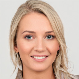 Joyful white young-adult female with long  brown hair and blue eyes