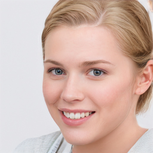 Joyful white young-adult female with medium  brown hair and blue eyes