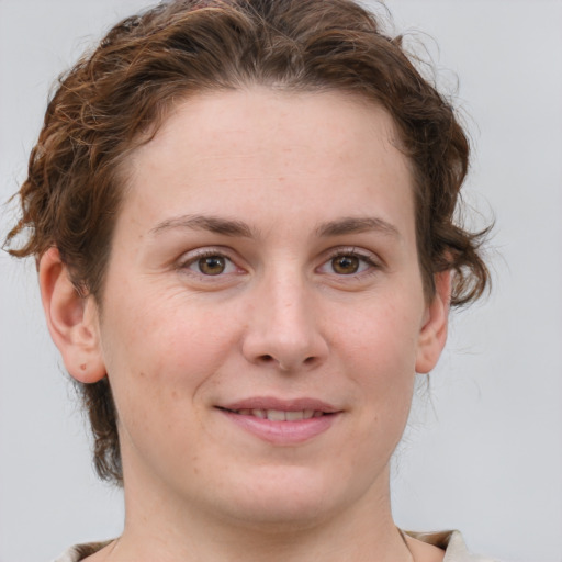 Joyful white young-adult female with medium  brown hair and green eyes