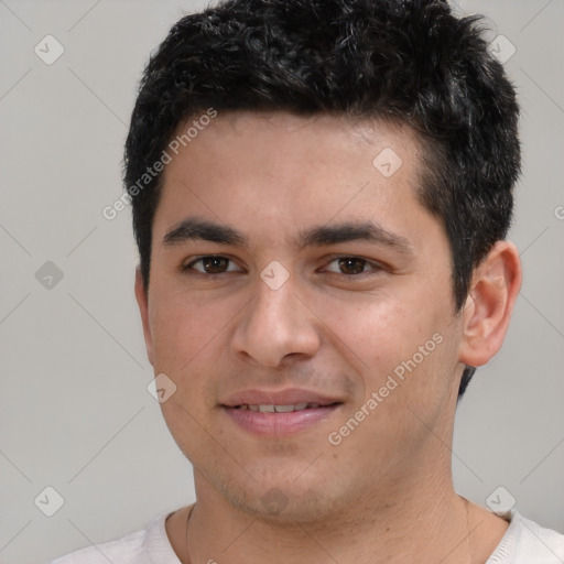 Joyful white young-adult male with short  black hair and brown eyes