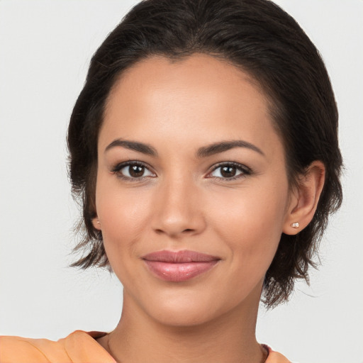 Joyful latino young-adult female with medium  brown hair and brown eyes