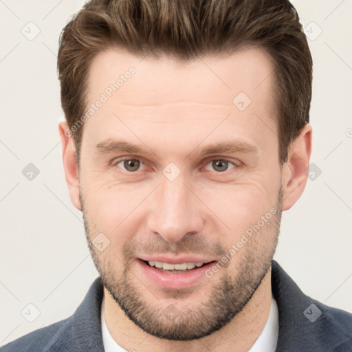 Joyful white young-adult male with short  brown hair and grey eyes