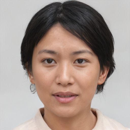 Joyful asian young-adult female with medium  brown hair and brown eyes