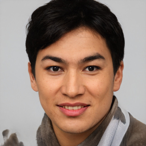 Joyful asian young-adult male with short  brown hair and brown eyes