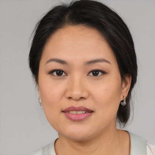 Joyful asian young-adult female with medium  brown hair and brown eyes