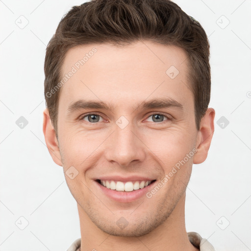 Joyful white young-adult male with short  brown hair and grey eyes