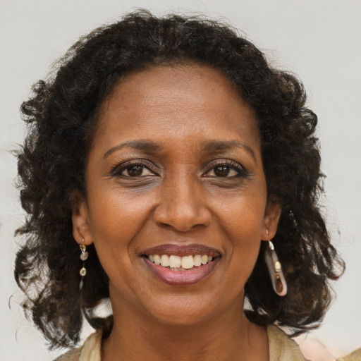 Joyful black adult female with medium  brown hair and brown eyes