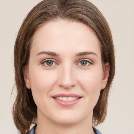 Joyful white young-adult female with medium  brown hair and blue eyes