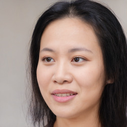 Joyful asian young-adult female with long  brown hair and brown eyes